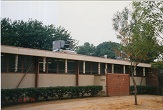 Classroom wing showing new rooftop package units and

original mechanical room at grade